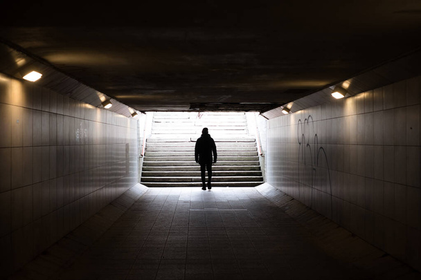 Man walking in dark underground tunnel. Stranger anonymous person. - Фото, зображення