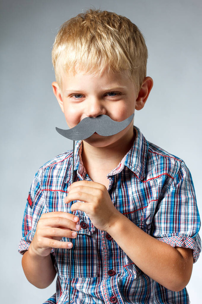 Cute boy wearing shirt hat and mustache - Фото, изображение