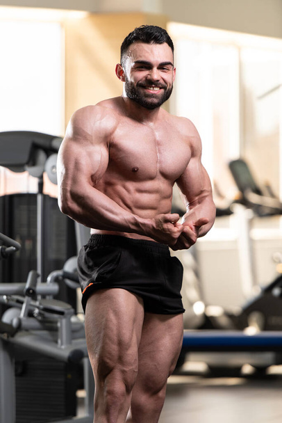 Portrait Of A Young Physically Fit Man Showing His Well Trained Body - Muscular Athletic Bodybuilder Fitness Model Posing After Exercises - Valokuva, kuva
