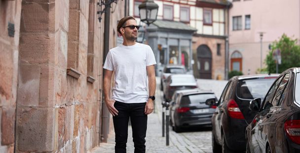 White blank t-shirt on a hipster handsome male model with space for your logo or design in casual urban style - Fotó, kép