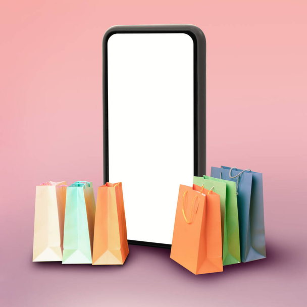 Smartphone με κενή οθόνη στέκεται κοντά σε τσάντες Shopper, ροζ φόντο - Φωτογραφία, εικόνα
