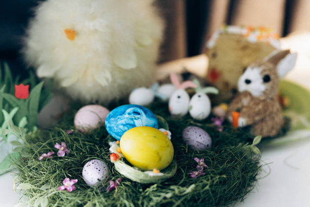 Decorated Ukrainian Easter with painted yellow and blue eggs stands on the table. Ukrainian Easter - 写真・画像
