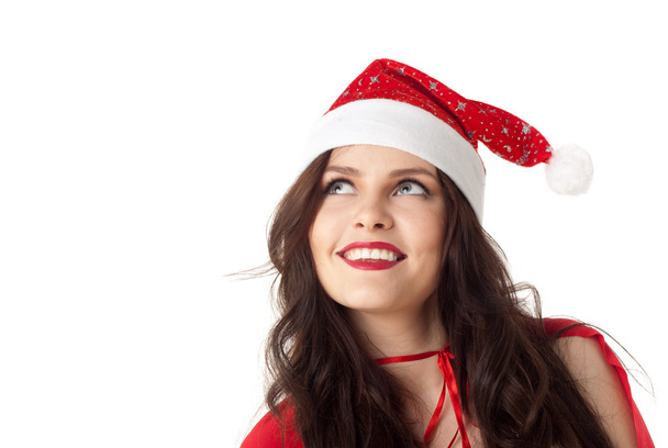 Smiling santa girl looking on copyspace - isolated over white - Foto, Imagem