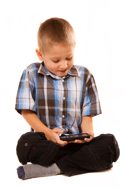 Boy playing games on smartphone - Fotografie, Obrázek