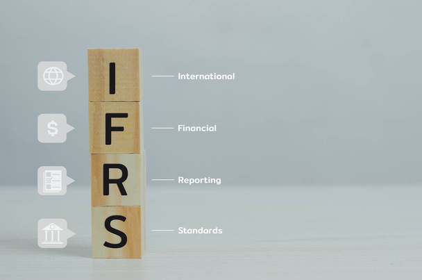wooden cubes IFRS International Financial Reporting Standards with on table and copy space.Business financial concepts. - Zdjęcie, obraz