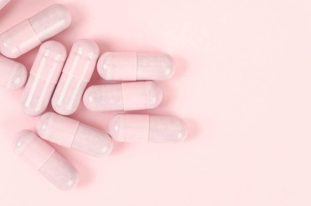 The Pink capsule pills on pink background  - Fotó, kép
