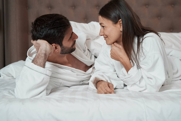 People in love talking while lying in bed - Photo, image