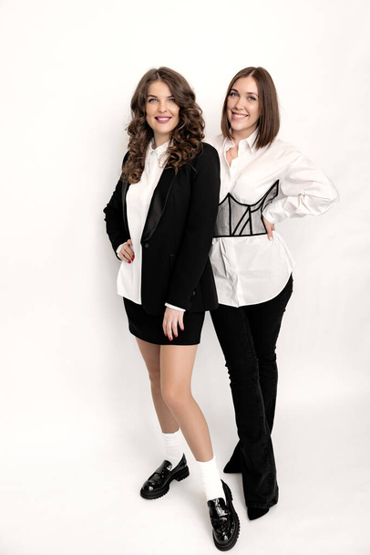Beautiful business women in stylish suits posing in studio on white background.  - Foto, Imagem