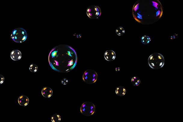 Soap bubbles isolated on a black background. Copy space.  - Valokuva, kuva