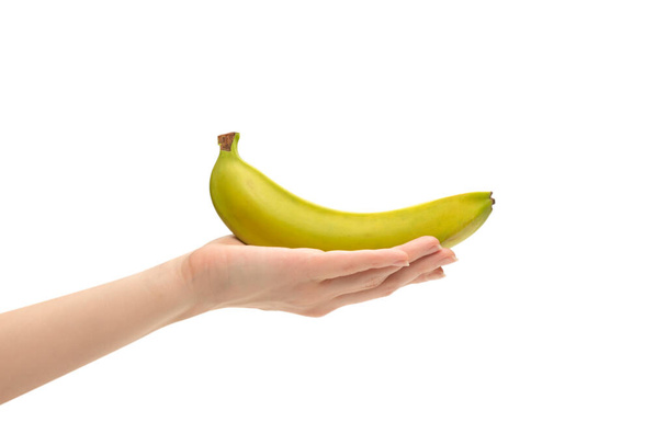 A bunch of bananas in woman hand isolated on a white background. - Фото, изображение