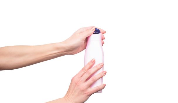 female hands holding shampoo bottle with copy space - Fotó, kép