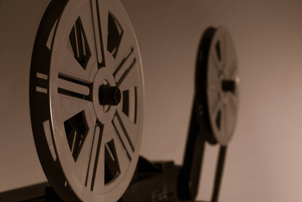 Old vintage 8mm projector with film reels and film frames. Copy space. Selective focus. - Foto, imagen