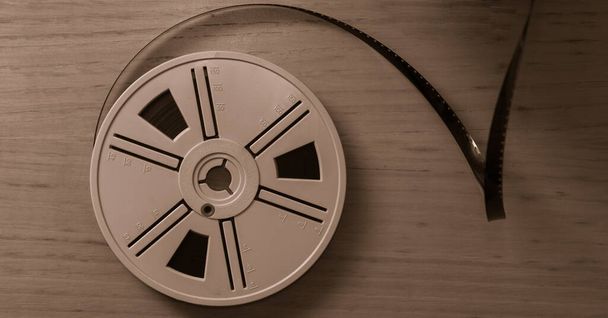 Vintage 8 mm film reels on wooden background. Copy space. Selective focus. - Photo, Image