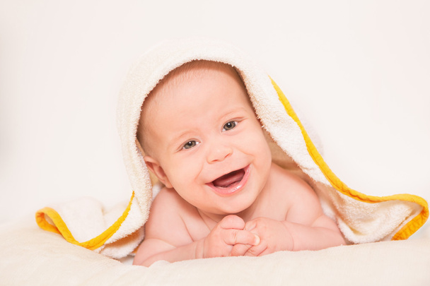 Newborn smiling on towel - Photo, Image