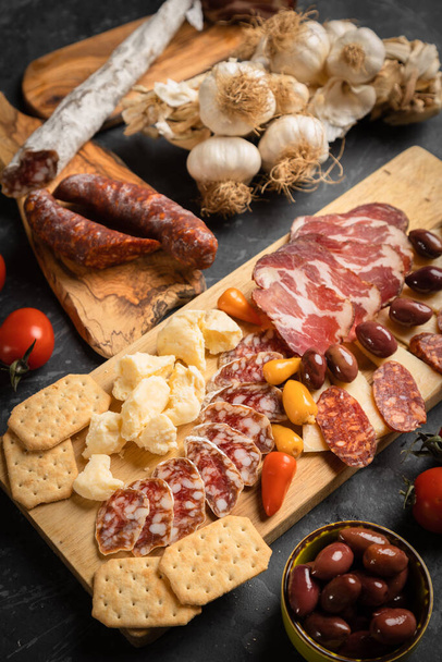 Charcuterie board with various cured meats and sausages - Фото, изображение