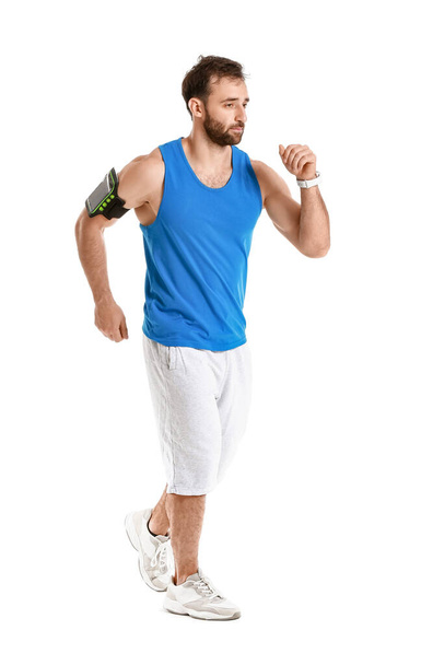 Sporty male runner on white background - Photo, Image