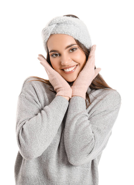 Young woman in warm gloves on white background - Фото, изображение