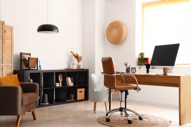 Stylish interior of light room with modern workplace - Foto, Imagen