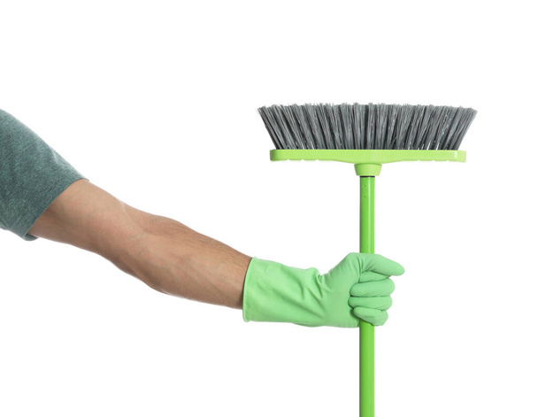 Man with green broom on white background, closeup - Foto, Bild