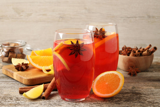 Aromatic punch drink and ingredients on wooden table - Φωτογραφία, εικόνα