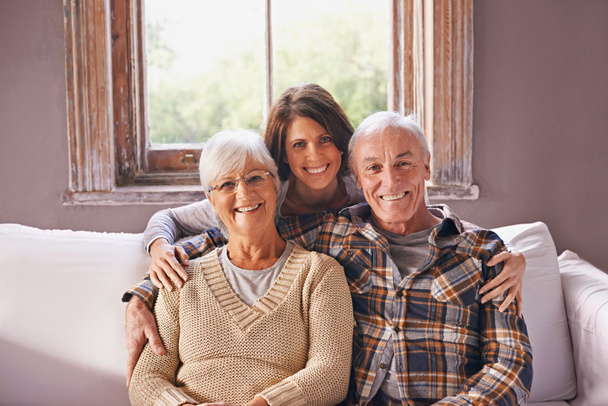 I love my parents. A cropped portrait of a happy senior couple and their adult daughter at home. - Foto, afbeelding