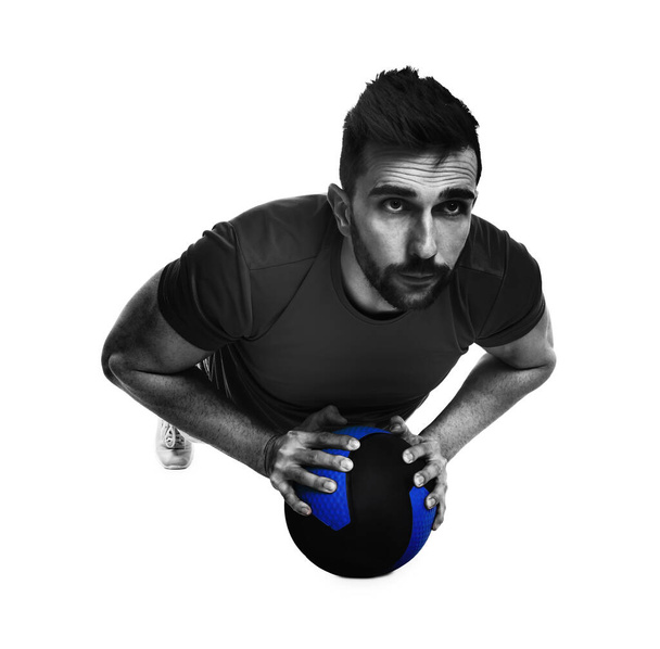 Athletic man doing exercise with medicine ball isolated on white - Foto, Bild