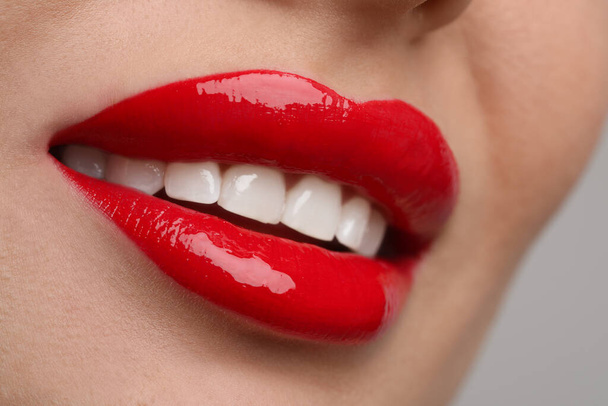 Young woman with perfect lips makeup on light background, closeup - Fotó, kép