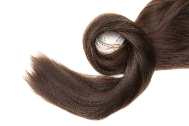 Beautiful strand of dark brown hair on white background, top view - Foto, Bild