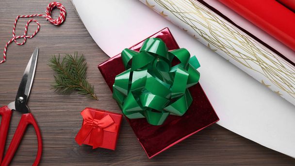 Flat lay composition with beautifully wrapped gift boxes on wooden table - Fotoğraf, Görsel