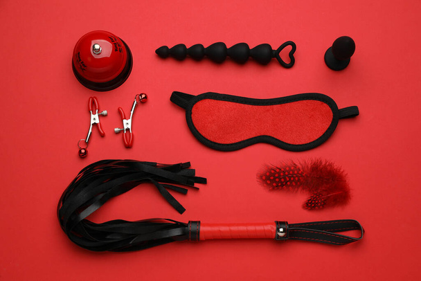 Sex toys and accessories on red background, flat lay - Φωτογραφία, εικόνα