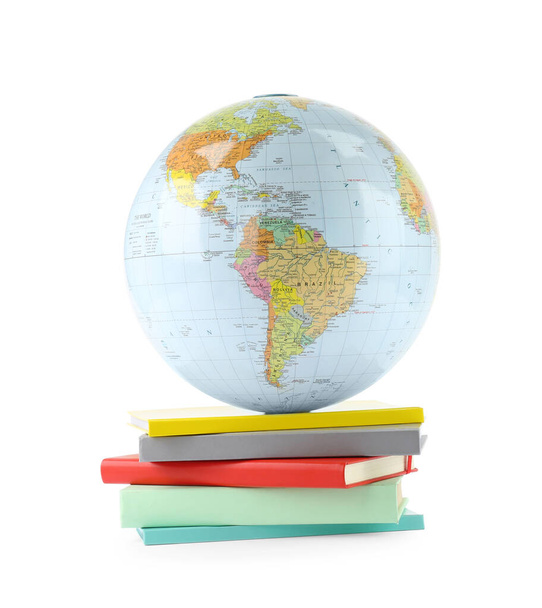 Plastic model globe of Earth and books on white background. Geography lesson - Foto, afbeelding