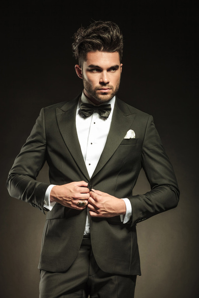 Elegant business man arranging his tuxedo - Photo, Image