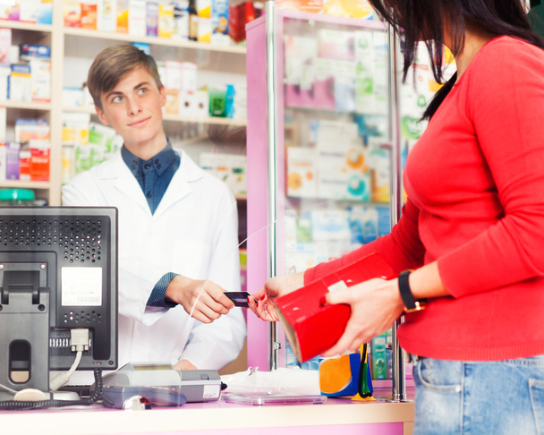 Customer paying with credit card in pharmacy - Photo, Image