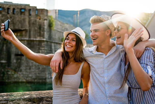 Happy group of young friends student enjoying travel and summer vacation together - Photo, image