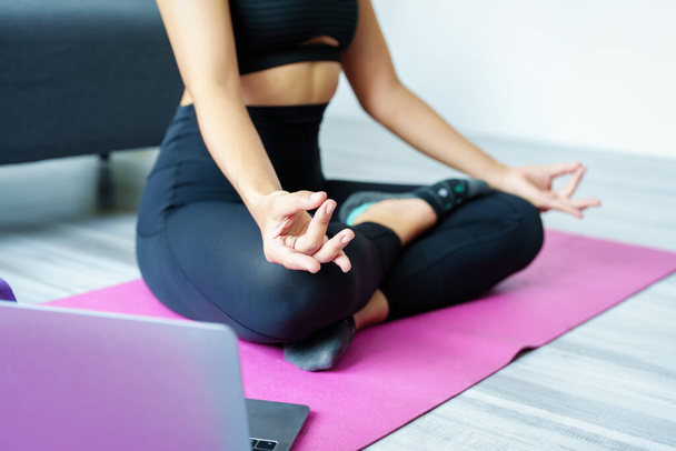 stress relief, muscle relaxation, breathing exercises, exercise, meditation, portrait of Young Asian woman relaxing her body from office work by practicing yoga by watching online tutorials. - Foto, Imagem