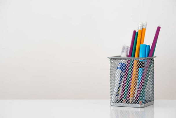 Stationery in a glass on a white background. Study, work, self-education. - Photo, Image