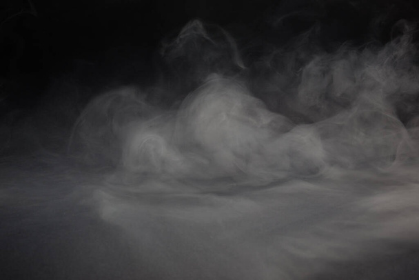 Cloud of white smoke on a black background closeup - Foto, imagen