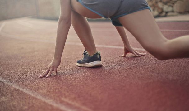 detail of woman legs on the track ready to go - Foto, Imagen