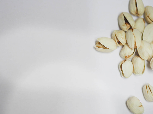Pistachio dried bean on white background, top view - 写真・画像