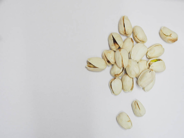 Pistachio dried bean on white background, top view - Foto, imagen