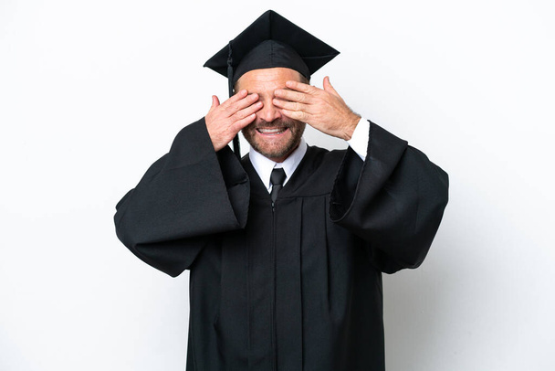 Middle age university graduate man isolated on white background covering eyes by hands - Foto, afbeelding