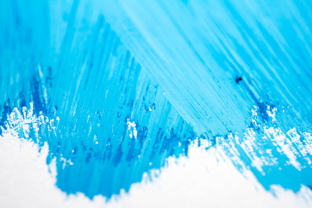 Extreme close up of blue acrylic paint texture showing brush strokes. Selective focus. - Fotó, kép