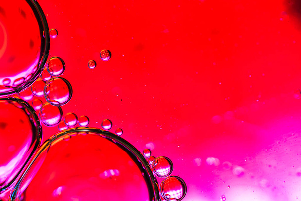 Abstract colorful backdrop with oil drops and waves on water surface. Abstract background concept - 写真・画像