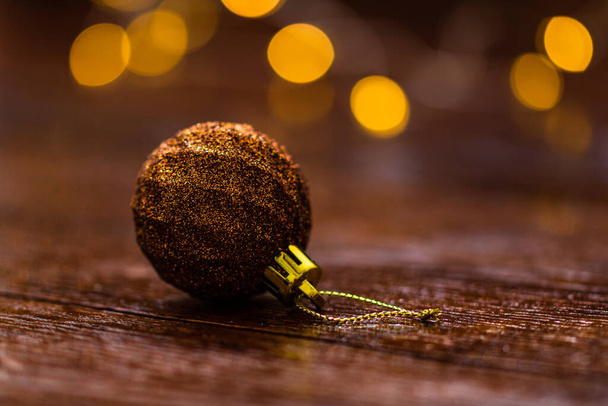 Christmas decorations against blurred background. Close up of  glittery Christmas ball. Christmas lights. - Photo, Image