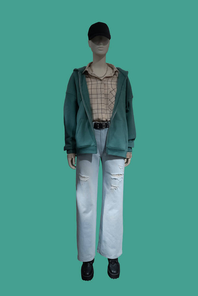 Full length image of a female display mannequin wearing fashionable clothes isolated on green background - Fotografie, Obrázek