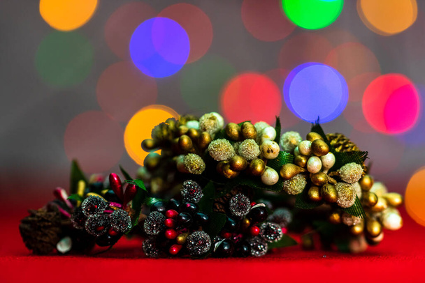 Красочные украшенные рождественские венки, изолированные на фоне размытых огней. - Фото, изображение
