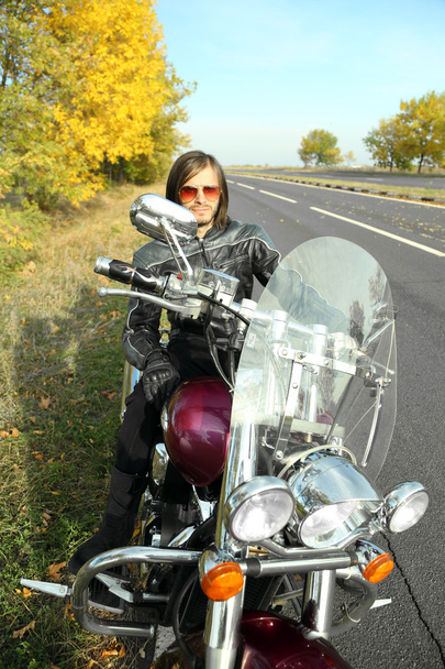 Motorcu adam bisiklet üzerinde oturur - Fotoğraf, Görsel