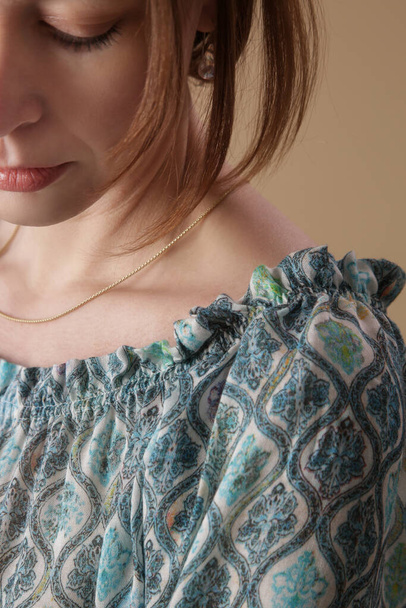 Close up of woman in textured linen blouse with blue geometric print - Photo, Image