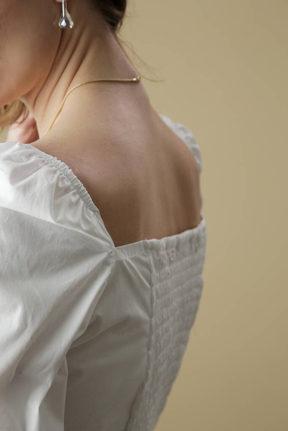 Fashion model wearing white peasant blouse, close up, studio shot. - Photo, Image