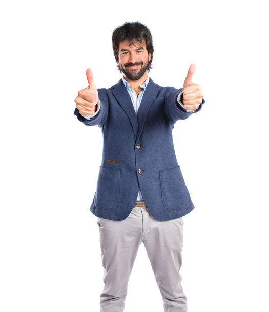 Handsome man with thumb up over white background - 写真・画像